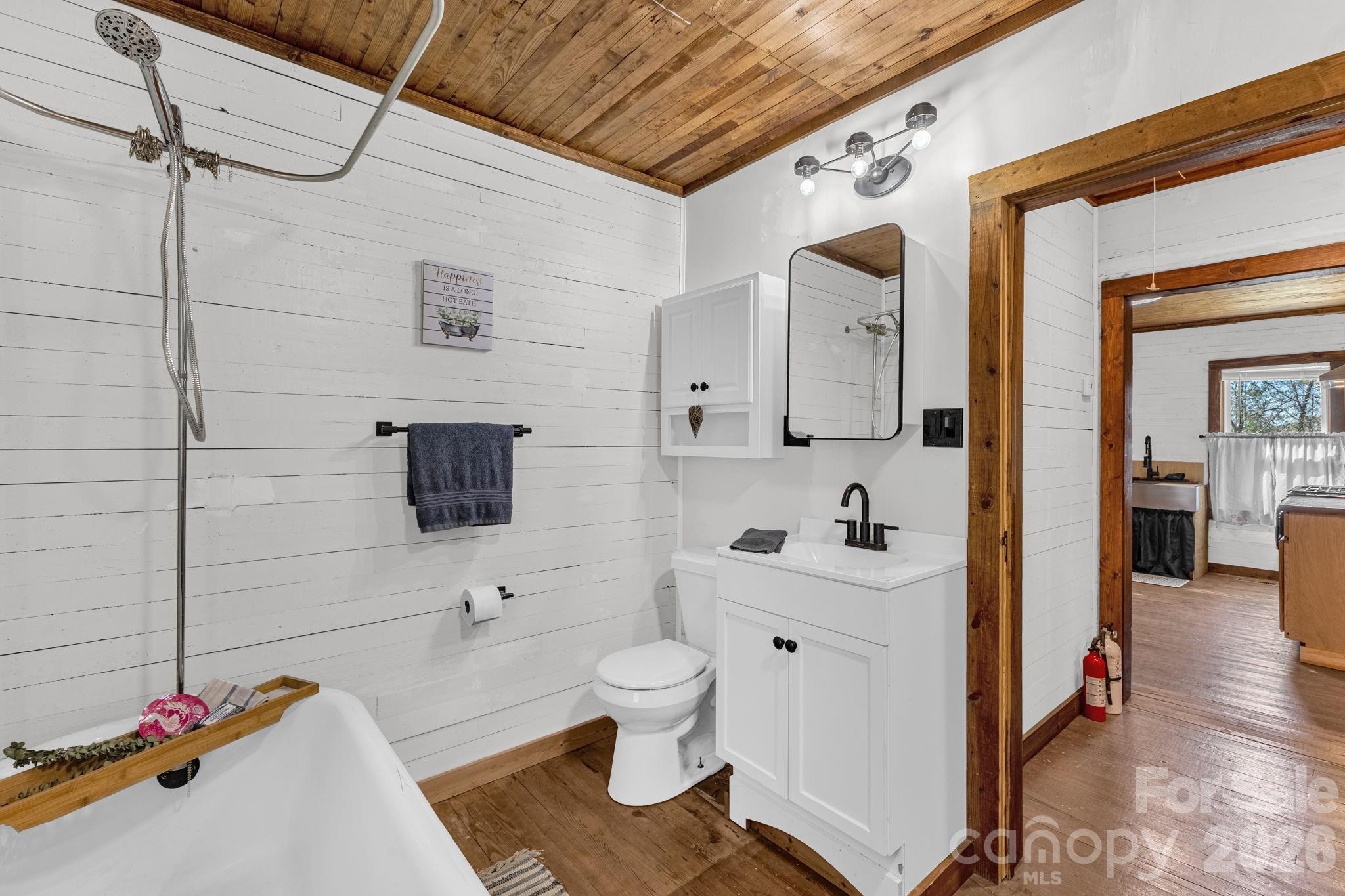 98 Poplar Springs Road Hiddenite, NC 28636 - Photo 27 of 37 a bathroom with a toilet sink a mirror and shower