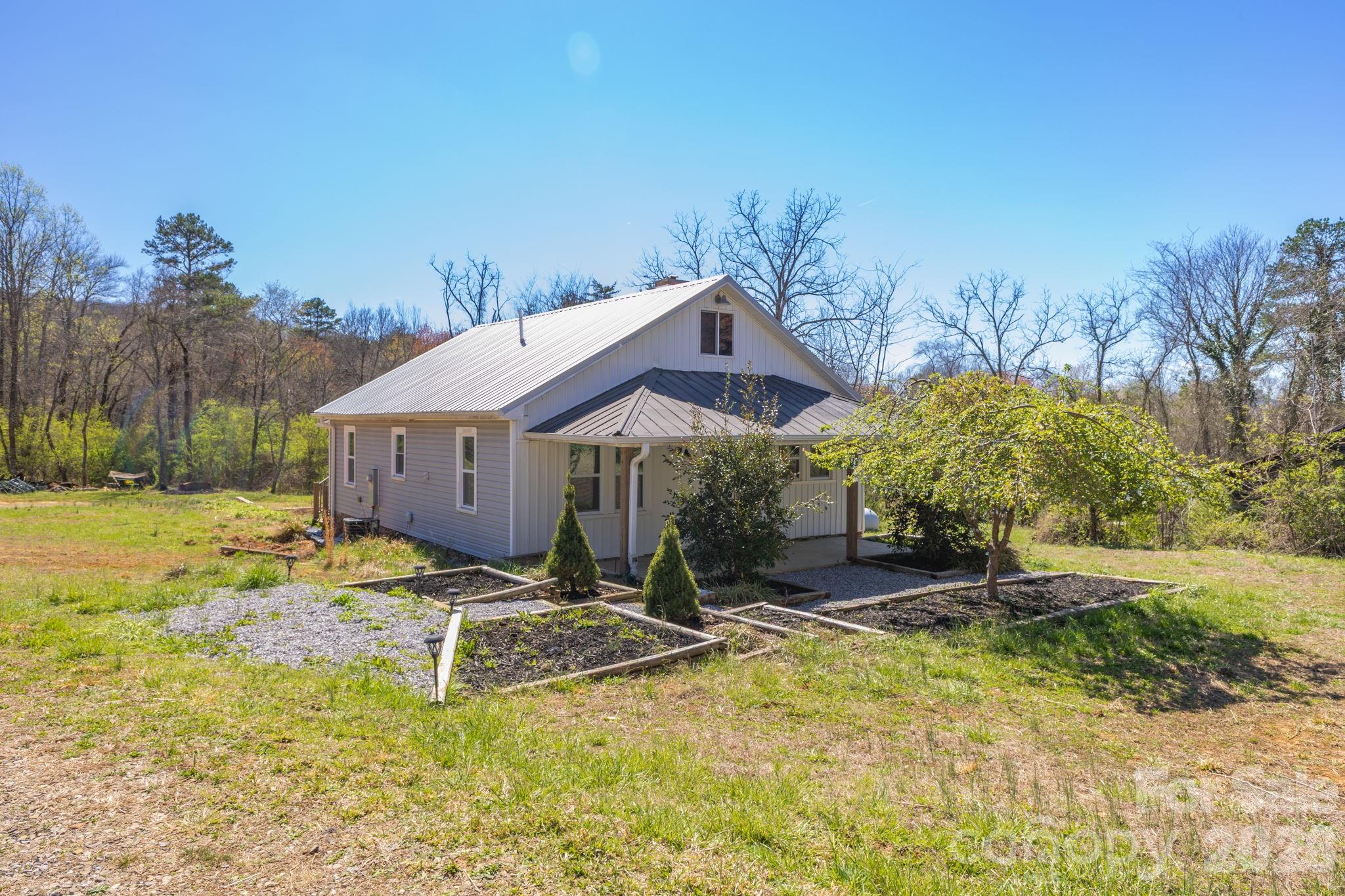 98 Poplar Springs Road Hiddenite, NC 28636 - Photo 33 of 37 a house with trees in the background