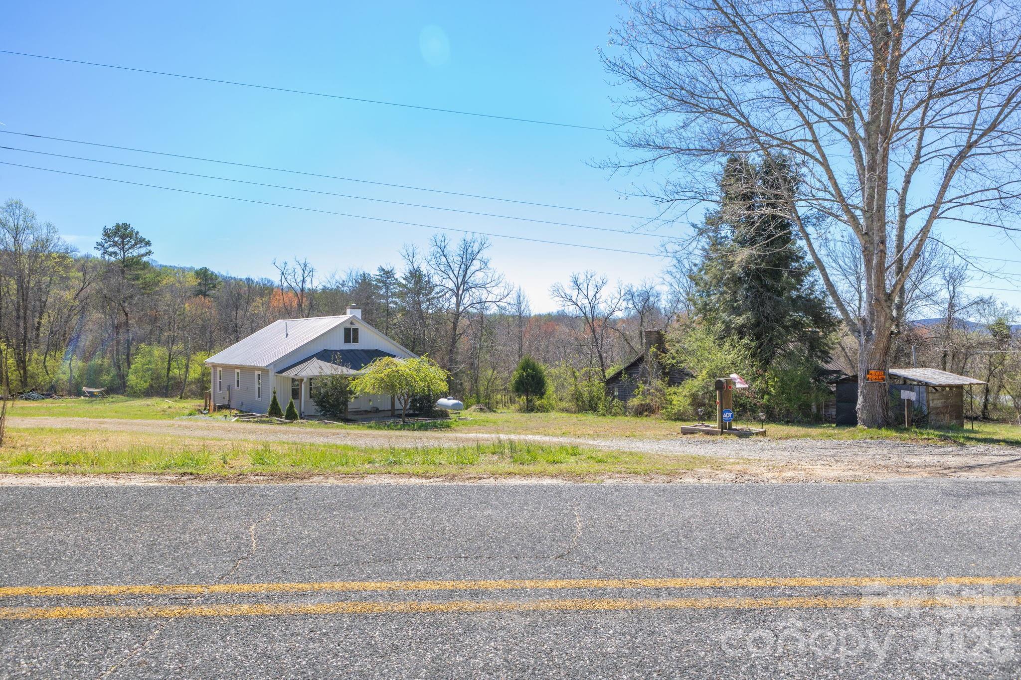 98 Poplar Springs Road Hiddenite, NC 28636 - Photo 35 of 37 a view of a house with a yard and a large tree