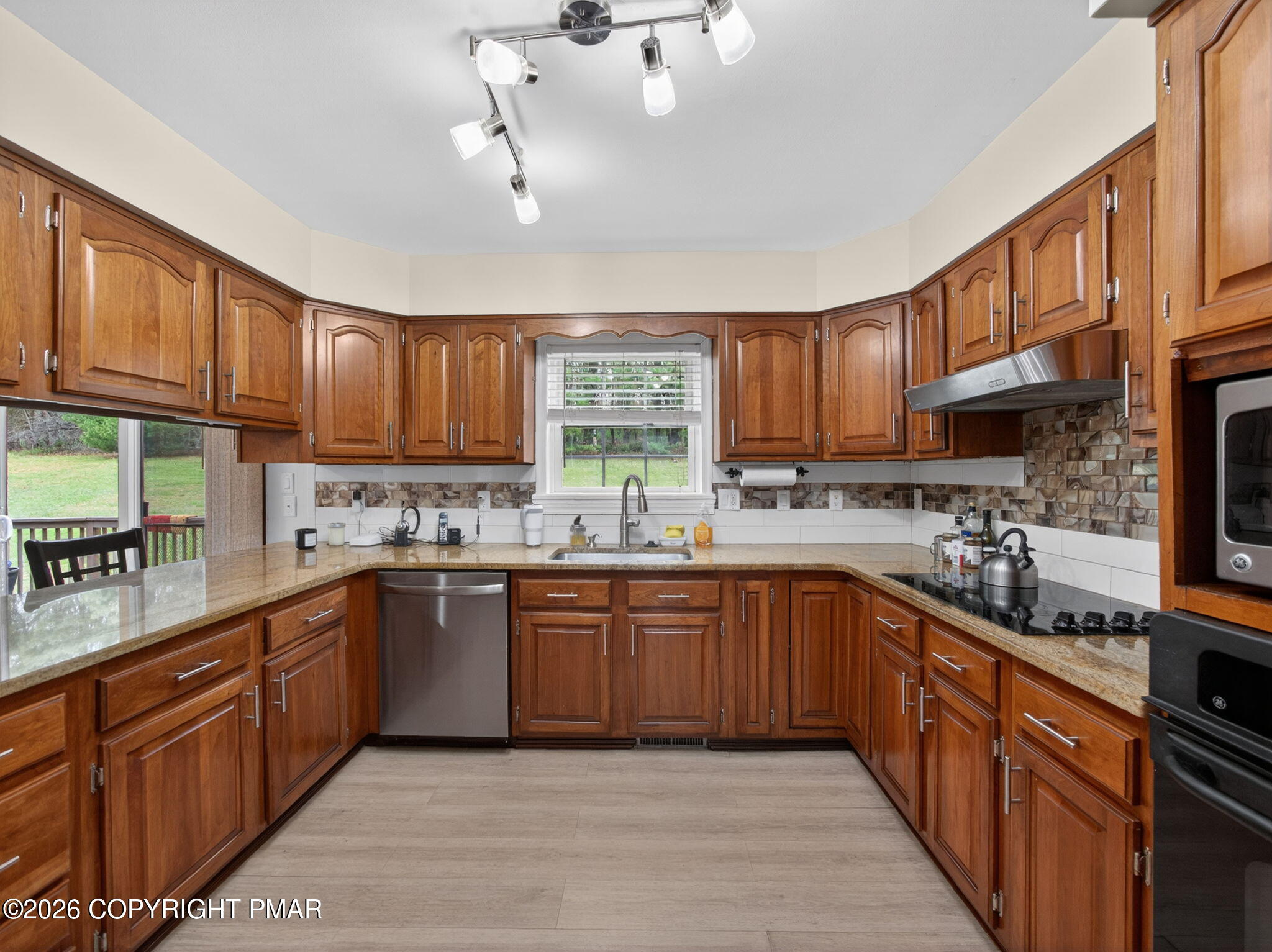 363 Blue Ridge Road Saylorsburg, PA 18353 - Photo 26 of 61 a kitchen with stainless steel appliances granite countertop wooden cabinets a stove a sink and a window