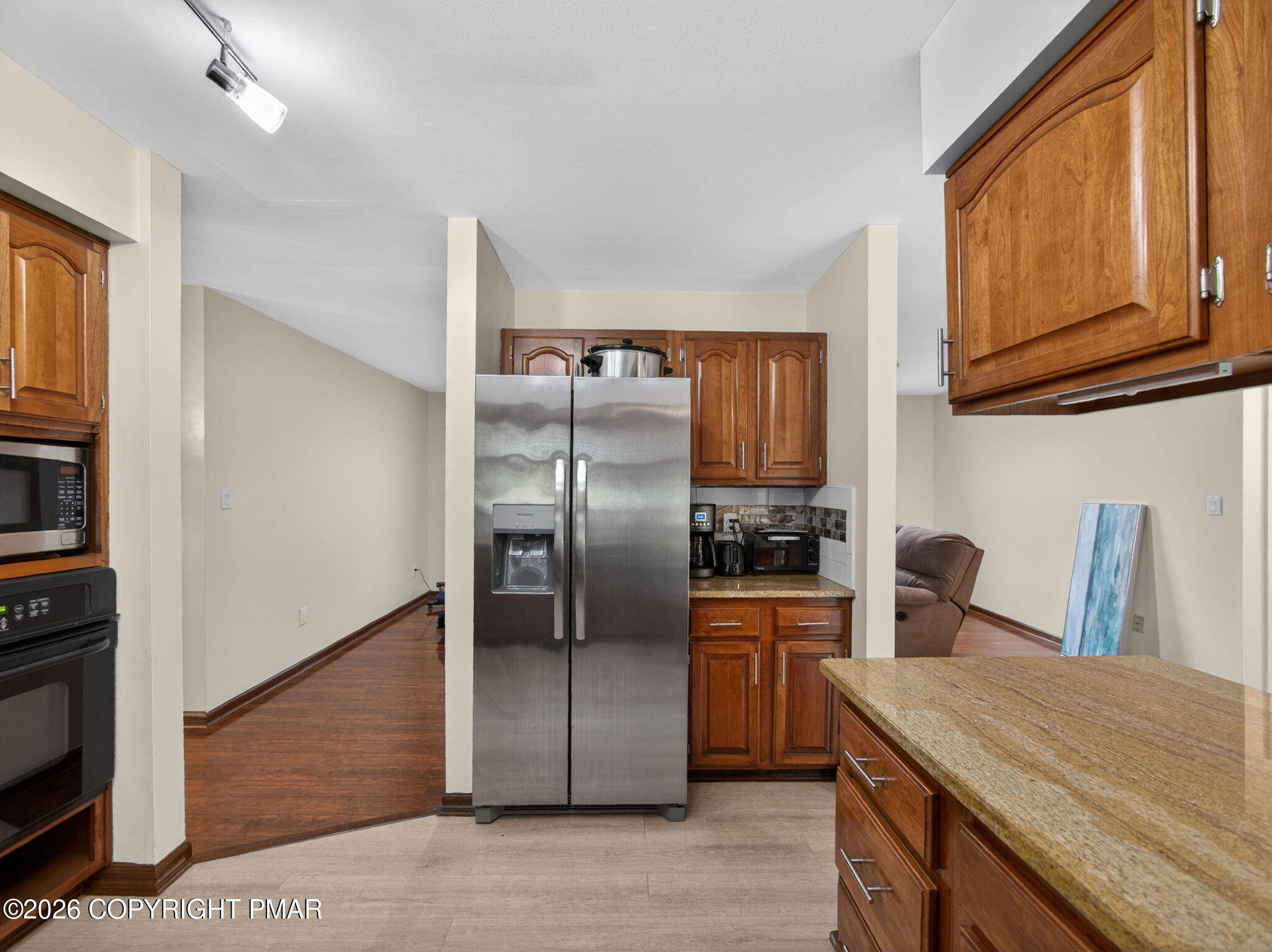 363 Blue Ridge Road Saylorsburg, PA 18353 - Photo 31 of 61 a kitchen with stainless steel appliances granite countertop a refrigerator a stove and a sink with wooden floor