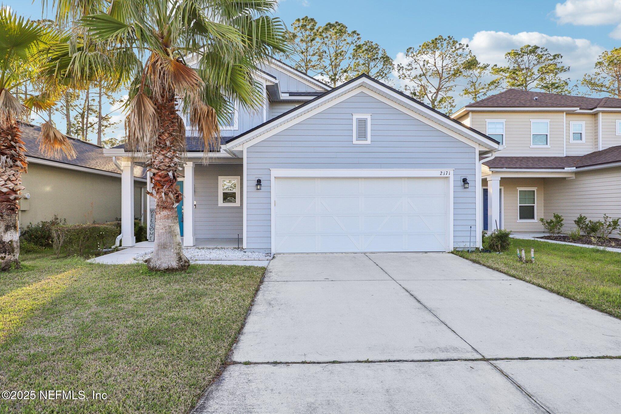 2171 Eagle Talon Circle Fleming Island, FL 32003 - Photo 1 of 44 a front view of a house with a yard and garage