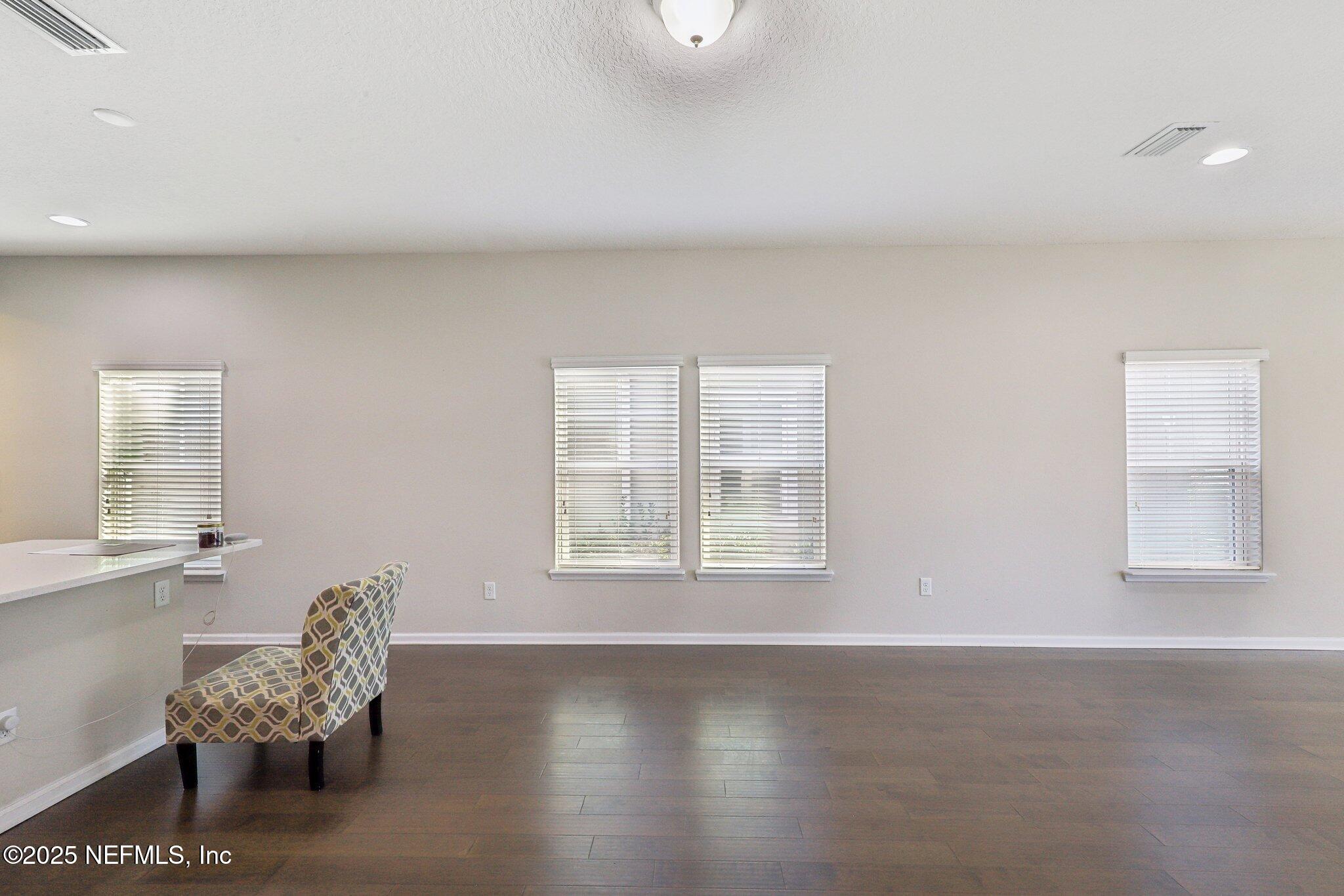 2171 Eagle Talon Circle Fleming Island, FL 32003 - Photo 11 of 44 a view of a livingroom with a chair and dining table chair