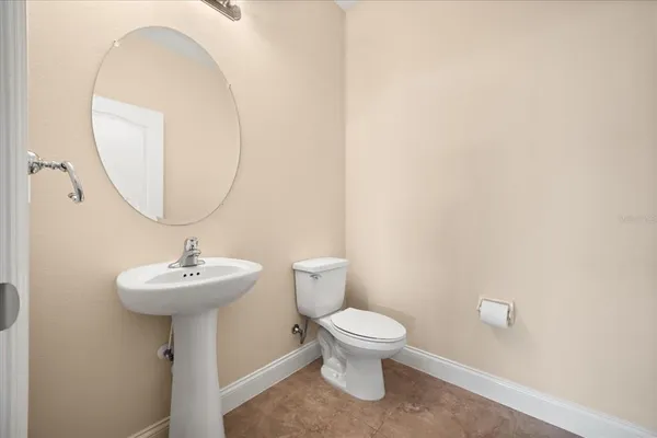 a bathroom with a sink a mirror and toilet