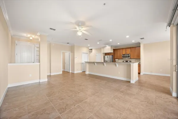 a view of a kitchen with a refrigerator and a sink
