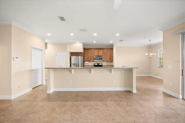 a view of kitchen with stainless steel appliances refrigerator sink and cabinets