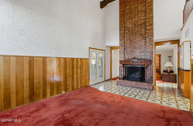 an empty room with a window and a ceiling fan