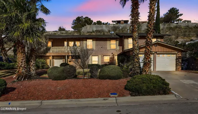 a view of a swimming pool with a bench and potted plants