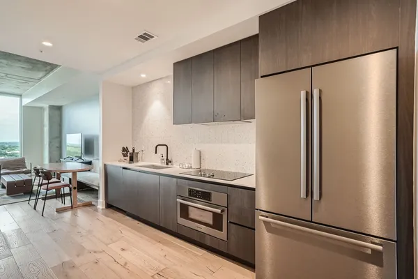 a kitchen with stainless steel appliances granite countertop a refrigerator and a sink
