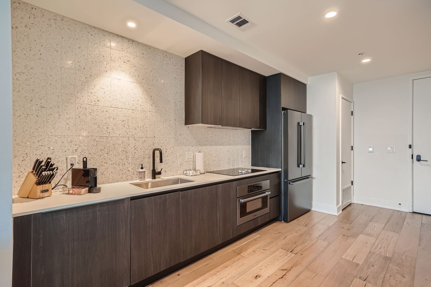 48 East Avenue, Unit 1706 Austin, TX 78701 - Photo 4 of 12 a kitchen with a sink cabinets and stainless steel appliances