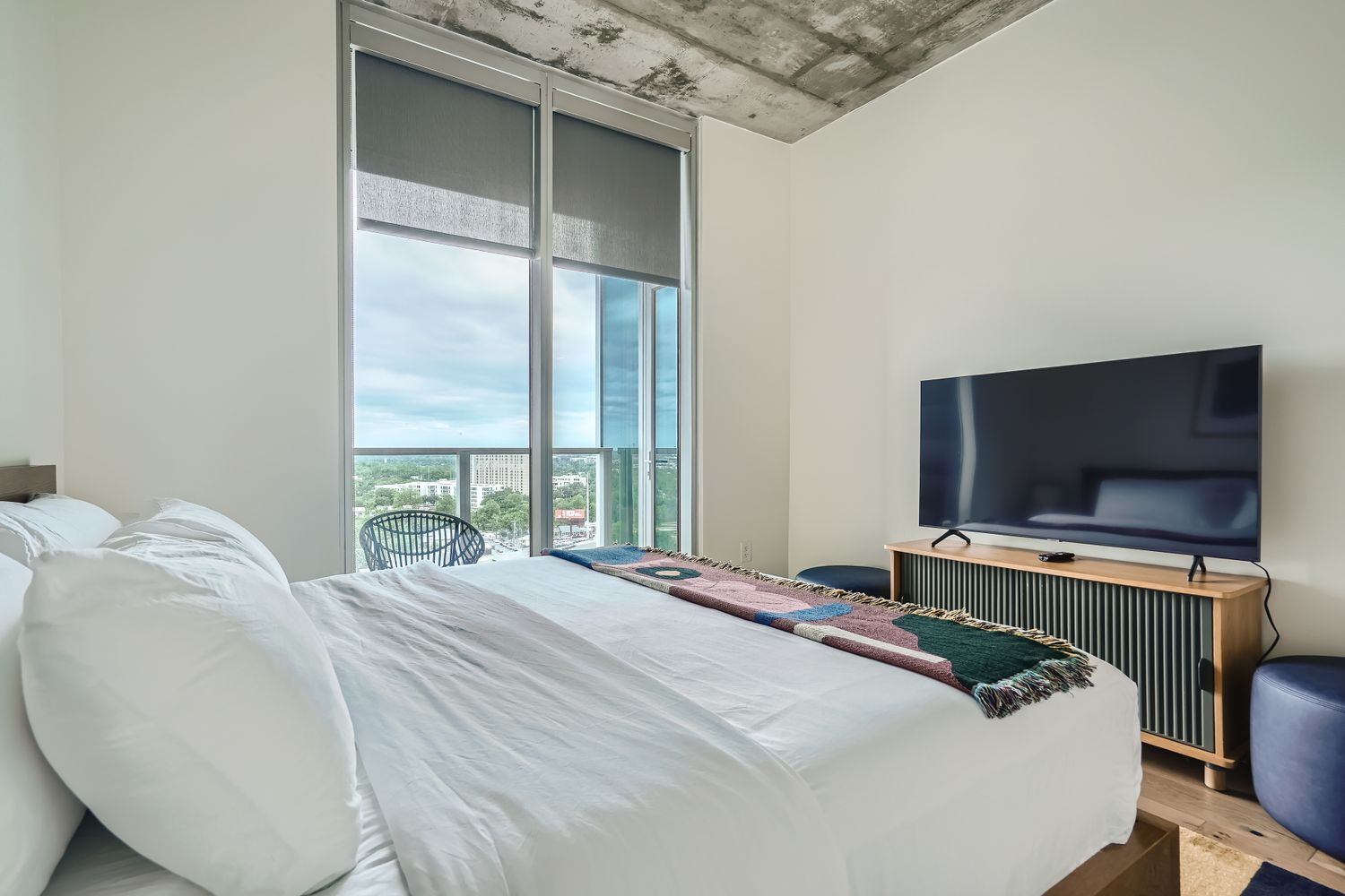 48 East Avenue, Unit 1706 Austin, TX 78701 - Photo 9 of 12 a bedroom with a bed and a flat screen tv