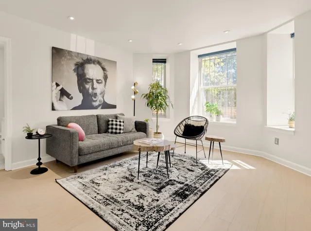 a living room with furniture and a large window