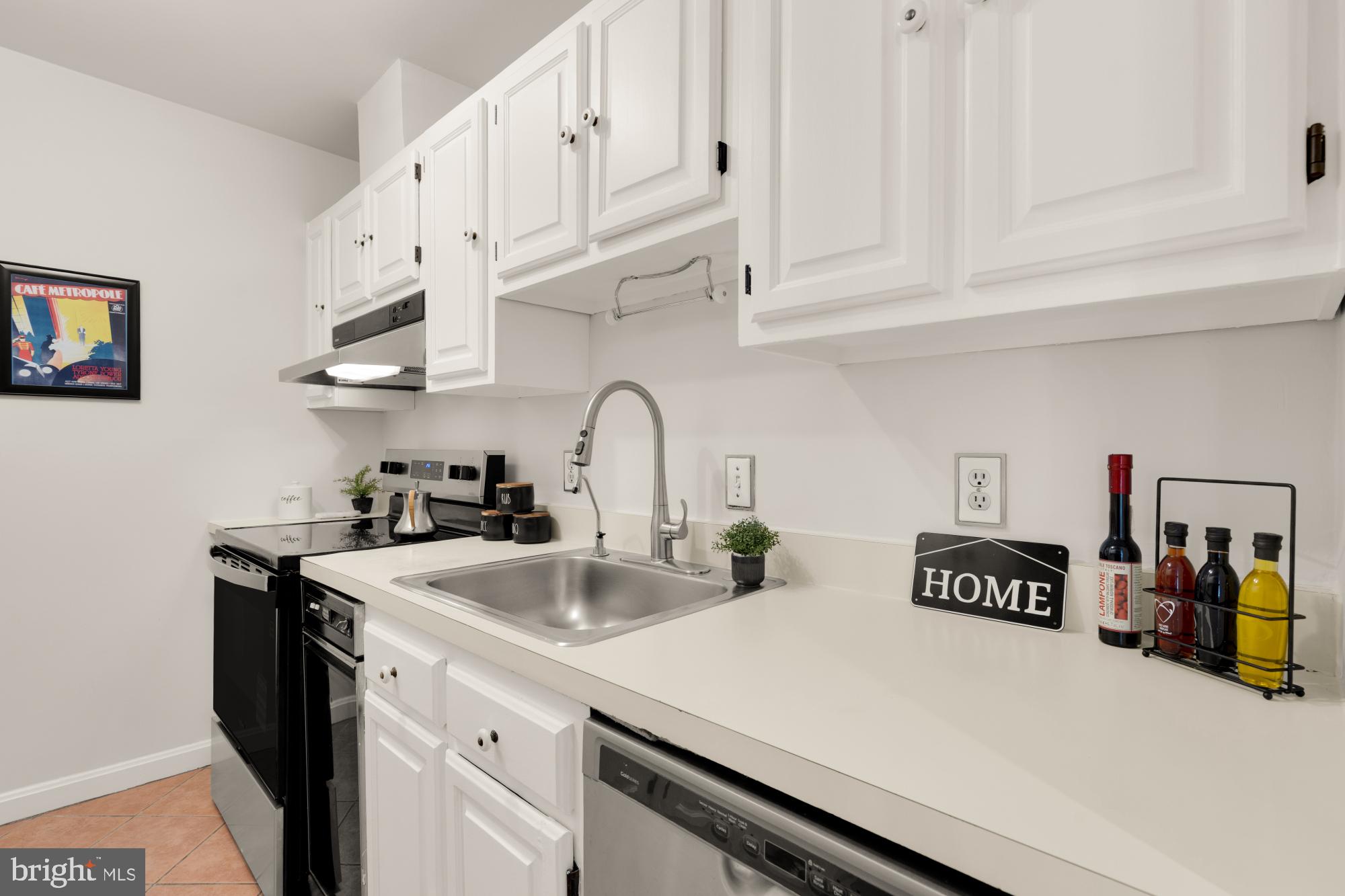 2000 16th Street Northwest, Unit 6 Washington, DC 20009 - Photo 18 of 37 a kitchen with stainless steel appliances granite countertop a sink a stove and white cabinets