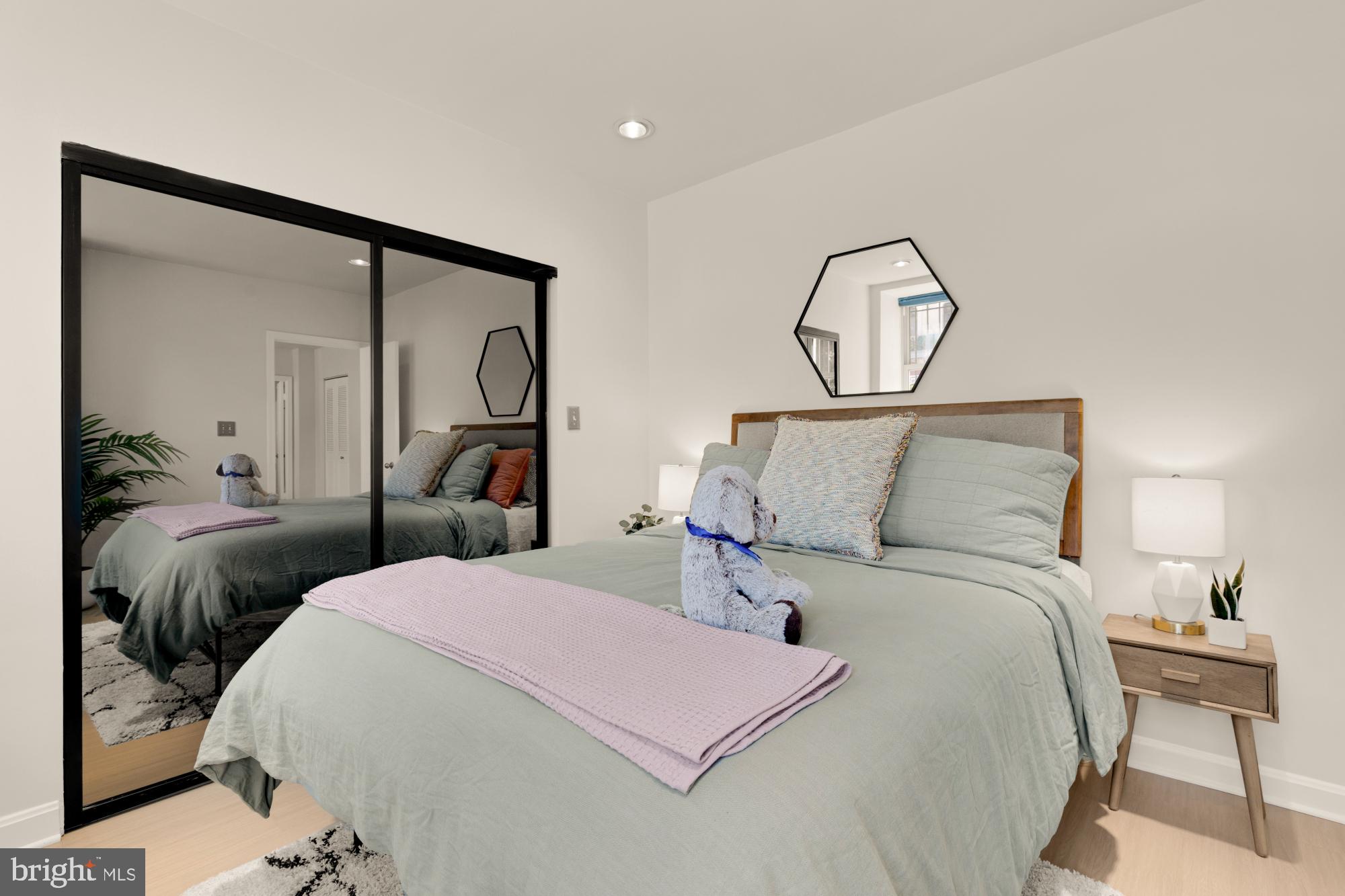 2000 16th Street Northwest, Unit 6 Washington, DC 20009 - Photo 25 of 37 a bedroom with a bed and a mirror