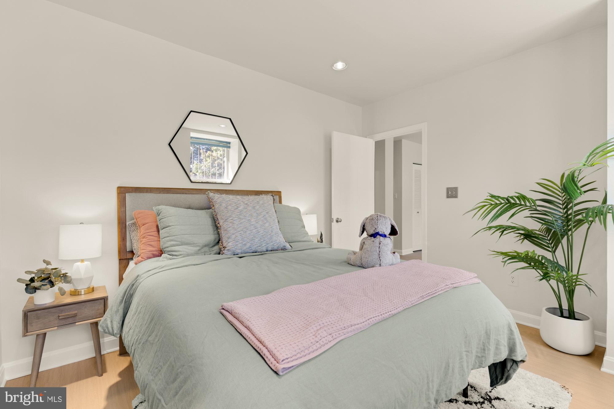 2000 16th Street Northwest, Unit 6 Washington, DC 20009 - Photo 30 of 37 a bedroom with a large bed and a potted plant