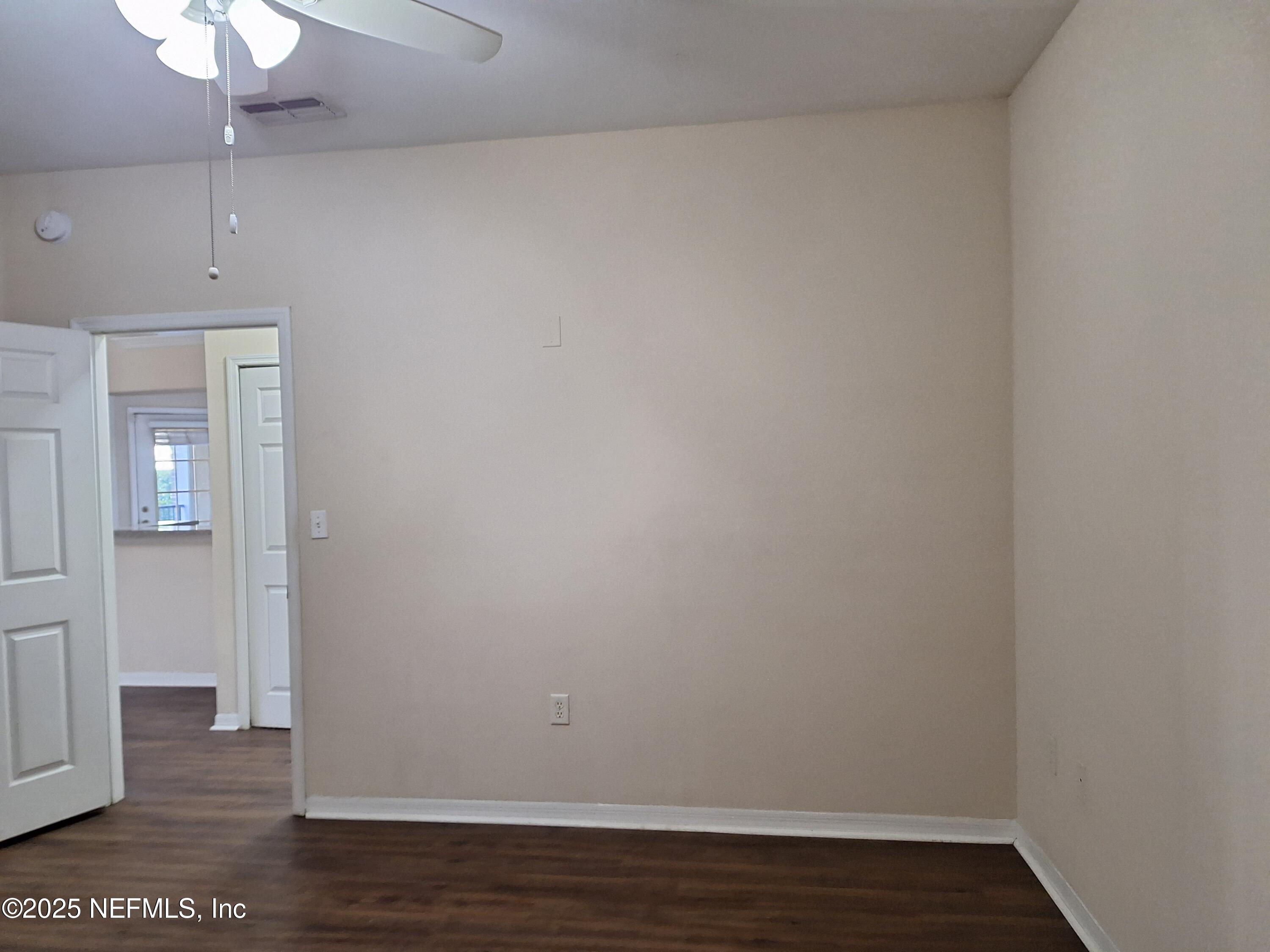 7800 Point Meadows Drive, Unit 116 Jacksonville, FL 32256 - Photo 14 of 29 a view of an empty room with wooden floor