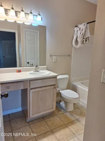 a bathroom with a bathtub and toilet