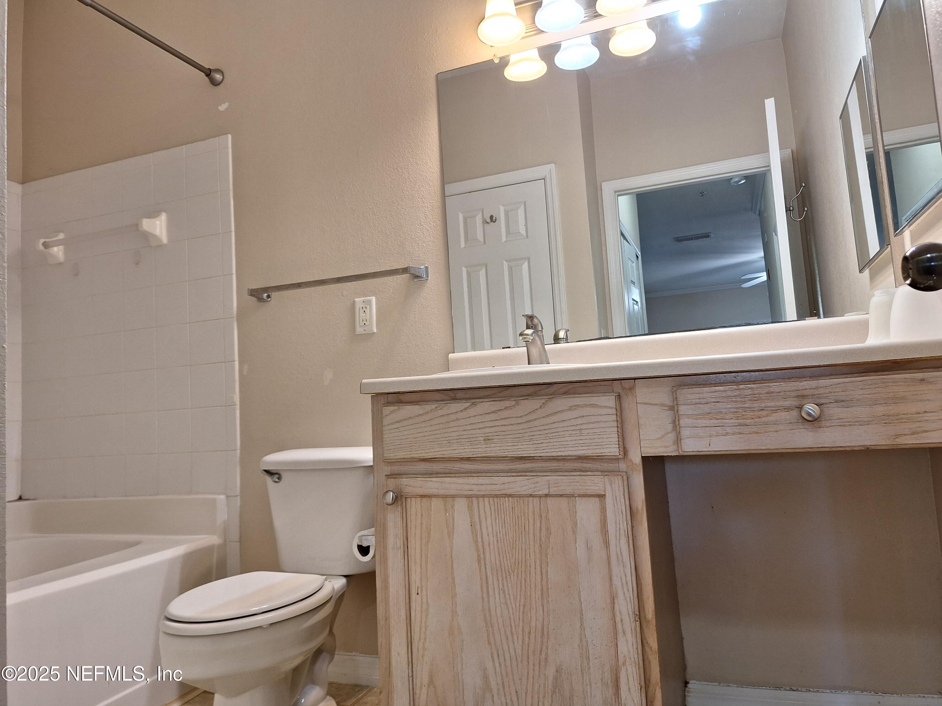 7800 Point Meadows Drive, Unit 116 Jacksonville, FL 32256 - Photo 21 of 29 a bathroom with a sink a toilet and shower