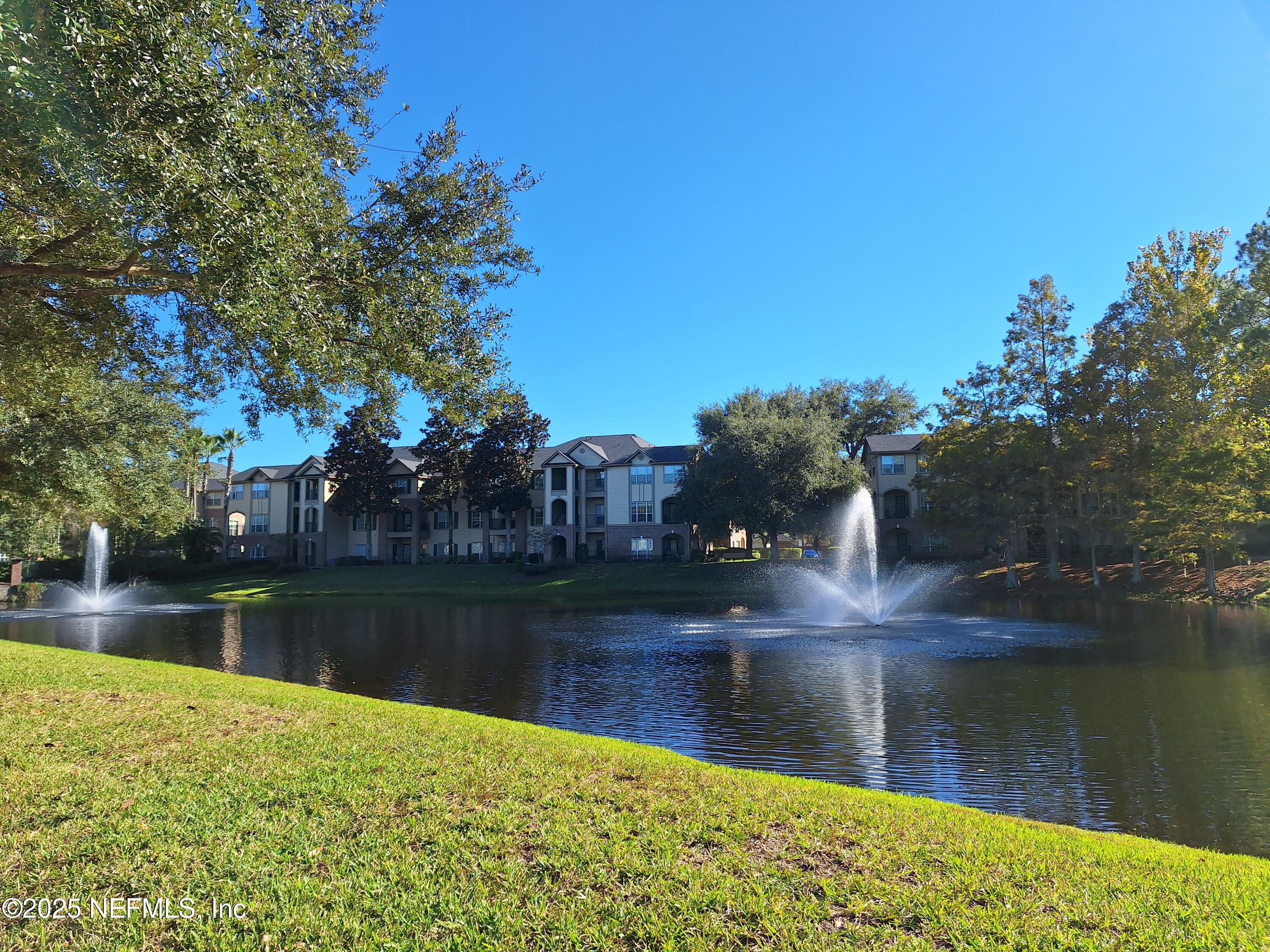 7800 Point Meadows Drive, Unit 116 Jacksonville, FL 32256 - Photo 24 of 29 a view of a lake with houses