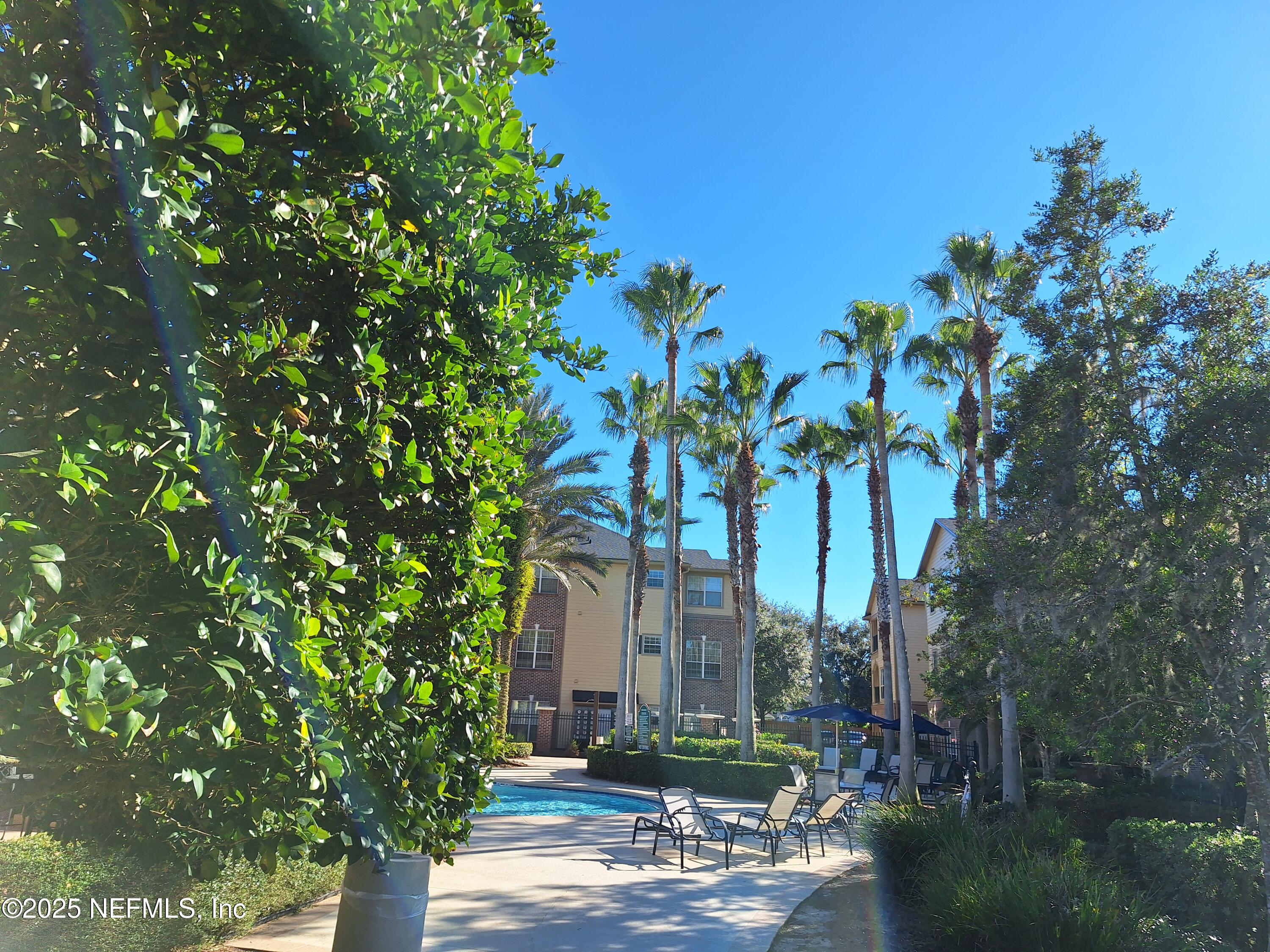 7800 Point Meadows Drive, Unit 116 Jacksonville, FL 32256 - Photo 25 of 29 a front view of a multi story building with yard