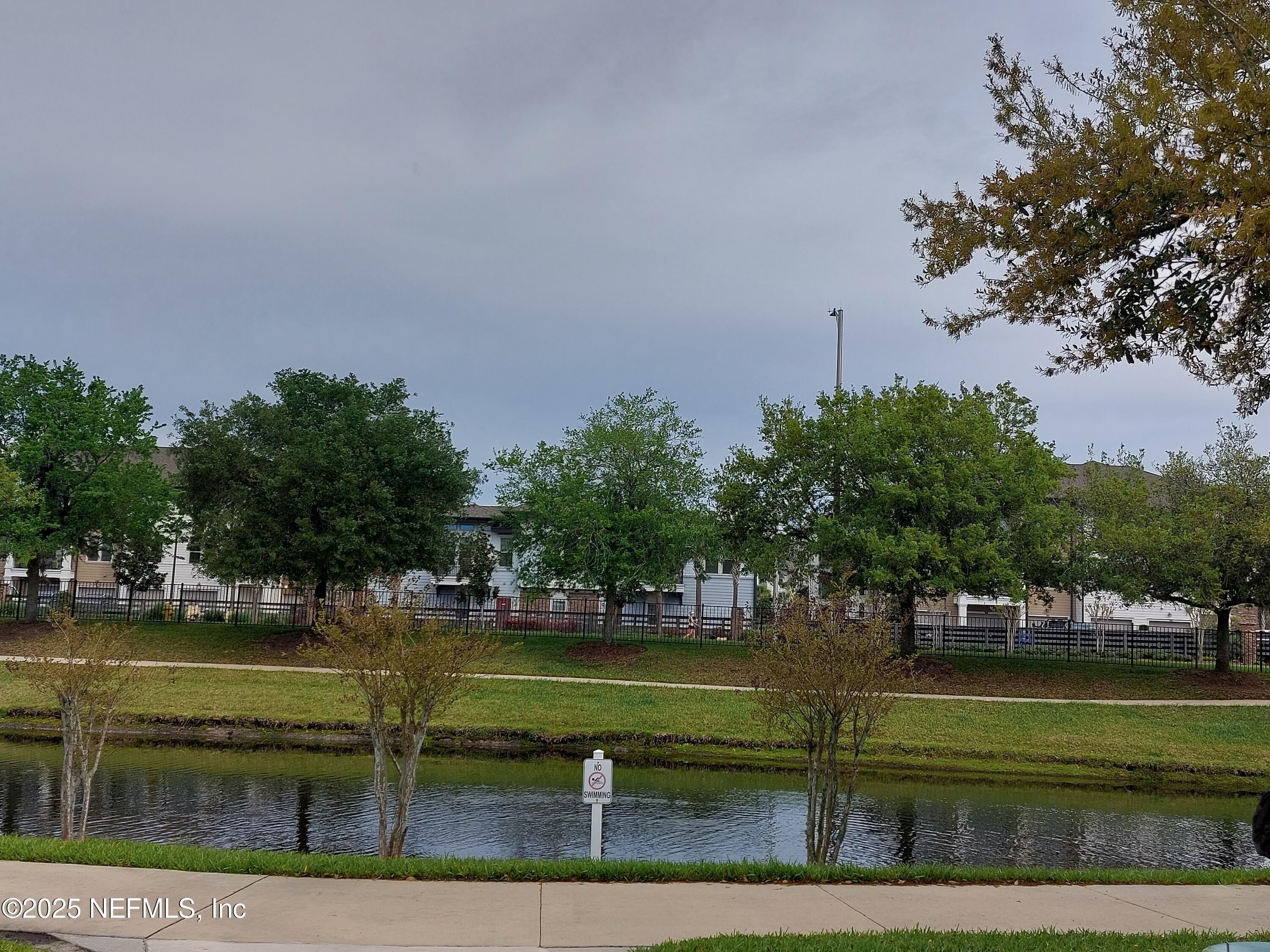 7800 Point Meadows Drive, Unit 116 Jacksonville, FL 32256 - Photo 29 of 29 a view of a lake with houses