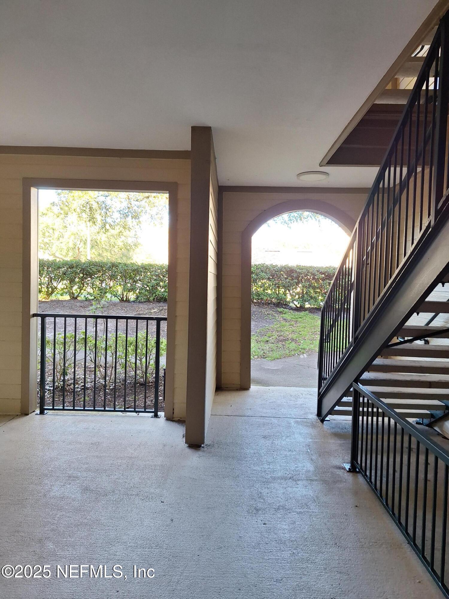7800 Point Meadows Drive, Unit 116 Jacksonville, FL 32256 - Photo 6 of 29 a view of hallway with wooden floor and fence