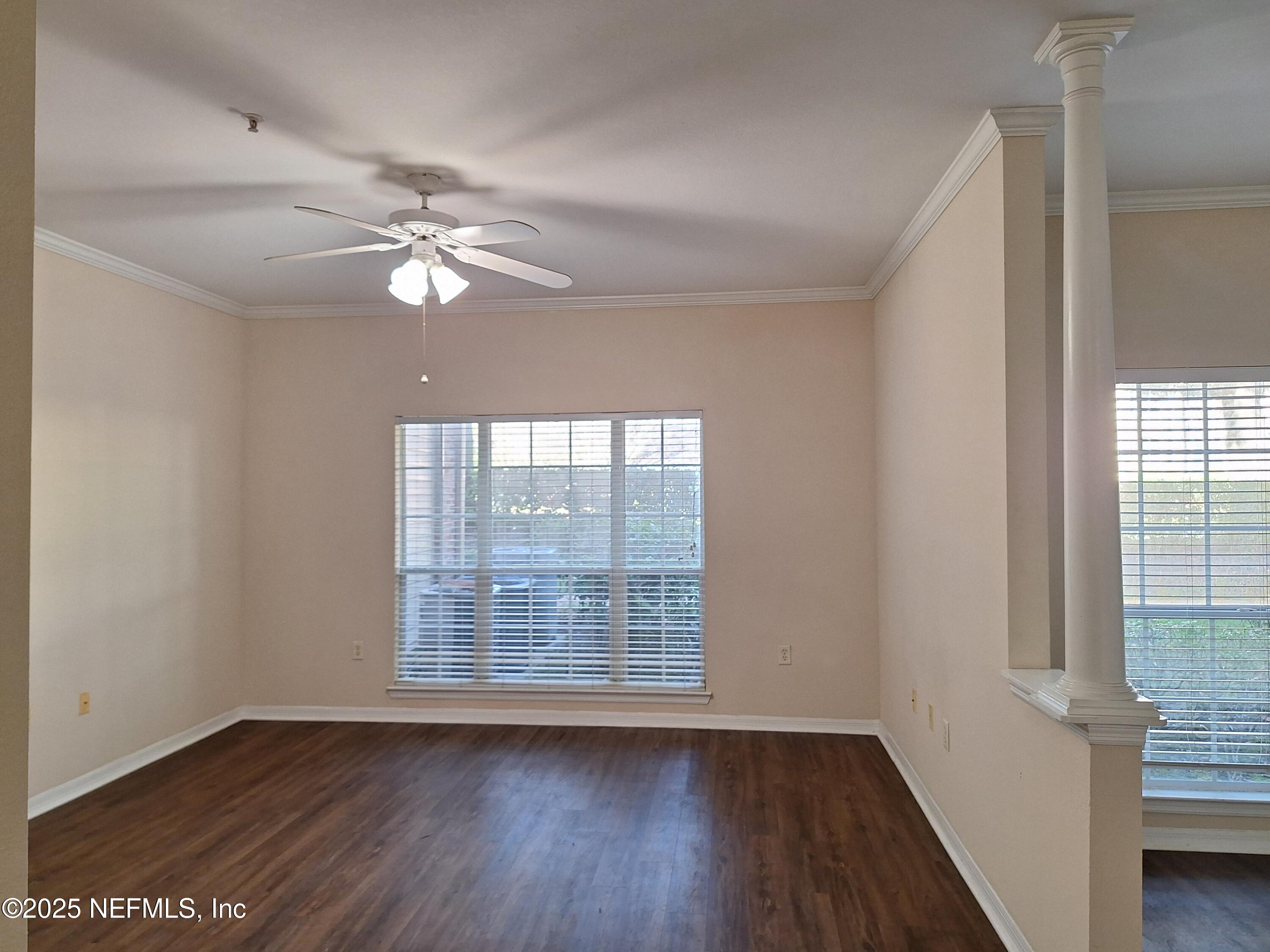 7800 Point Meadows Drive, Unit 116 Jacksonville, FL 32256 - Photo 9 of 29 wooden floor in an empty room with a window