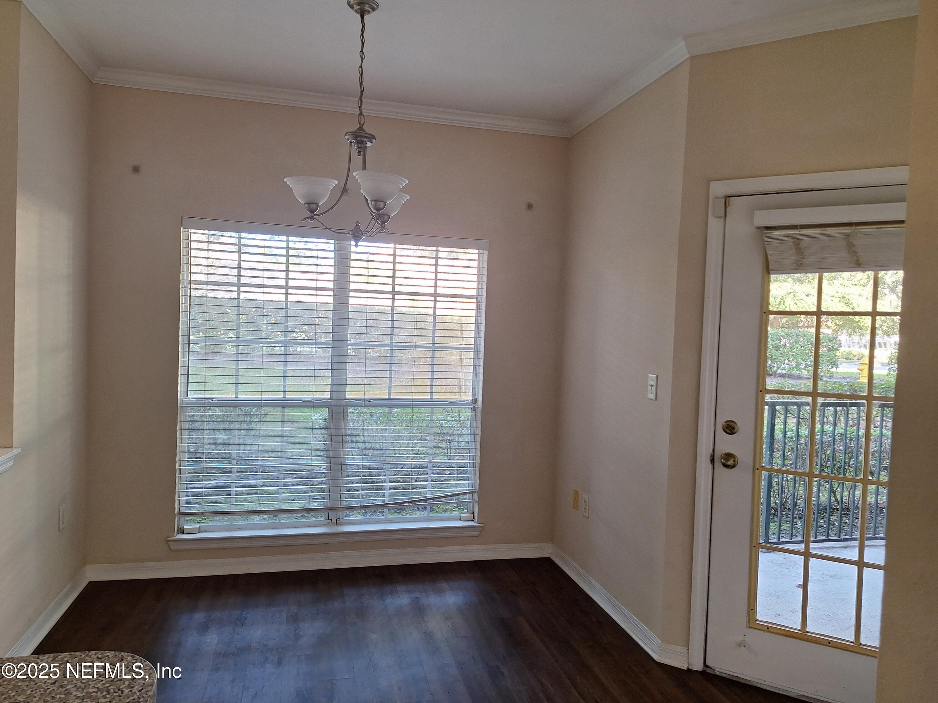 7800 Point Meadows Drive, Unit 116 Jacksonville, FL 32256 - Photo 10 of 29 a view of an empty room with wooden floor and a window