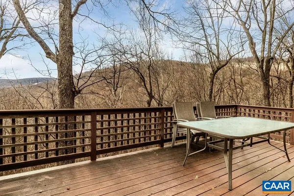 a view of a roof deck with wooden floor and barbeque oven