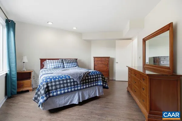 a bedroom with a bed and a dresser