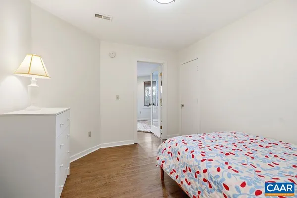 a bedroom with a bed and a lamp