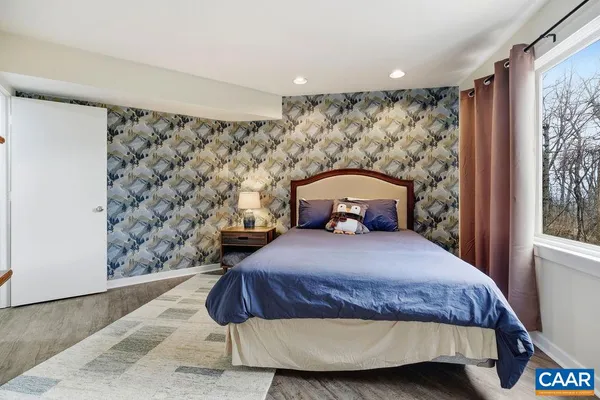 a bedroom with a bed and a window