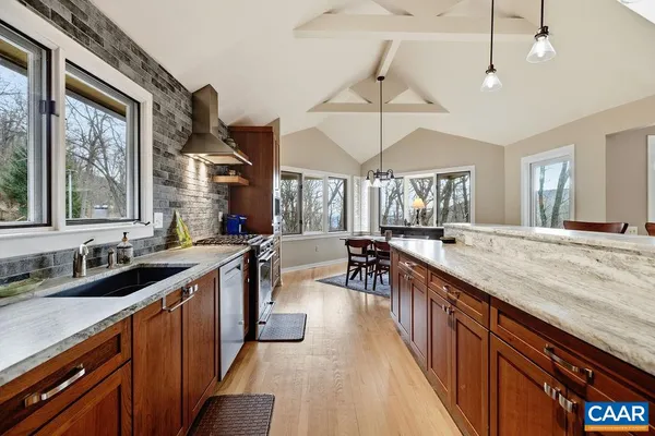 a large kitchen with stainless steel appliances a counter space a sink and dishwasher
