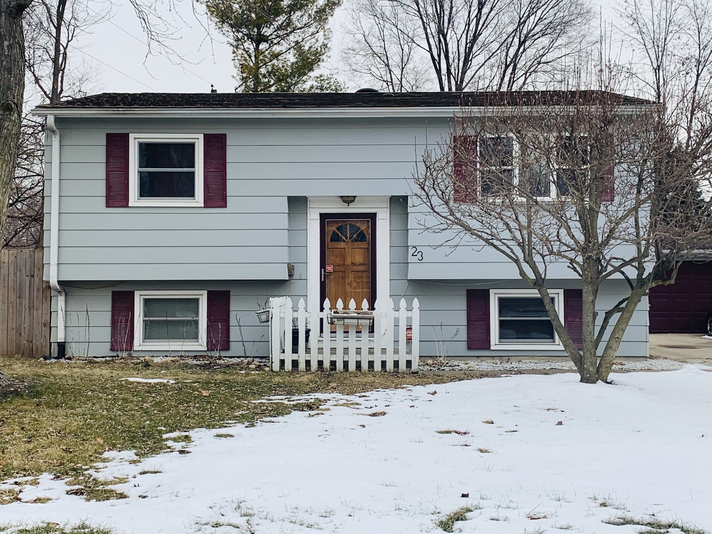 23 Surrey Road Montgomery, IL 60538 - Photo 1 of 22 a front view of a house with a yard covered with snow