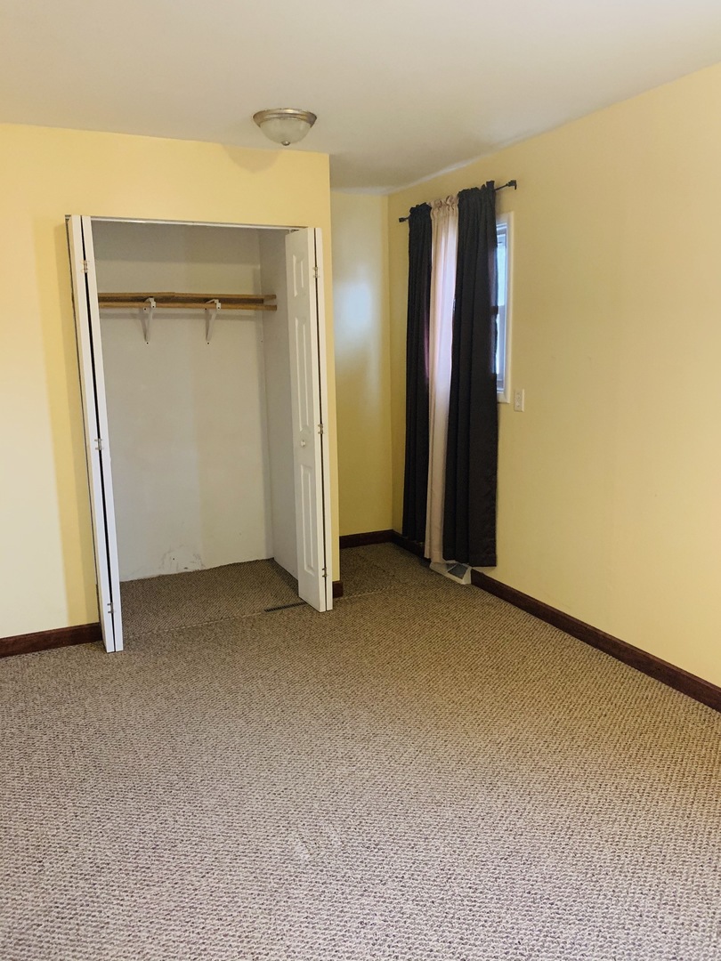 23 Surrey Road Montgomery, IL 60538 - Photo 13 of 22 an empty room with closet and wooden floor