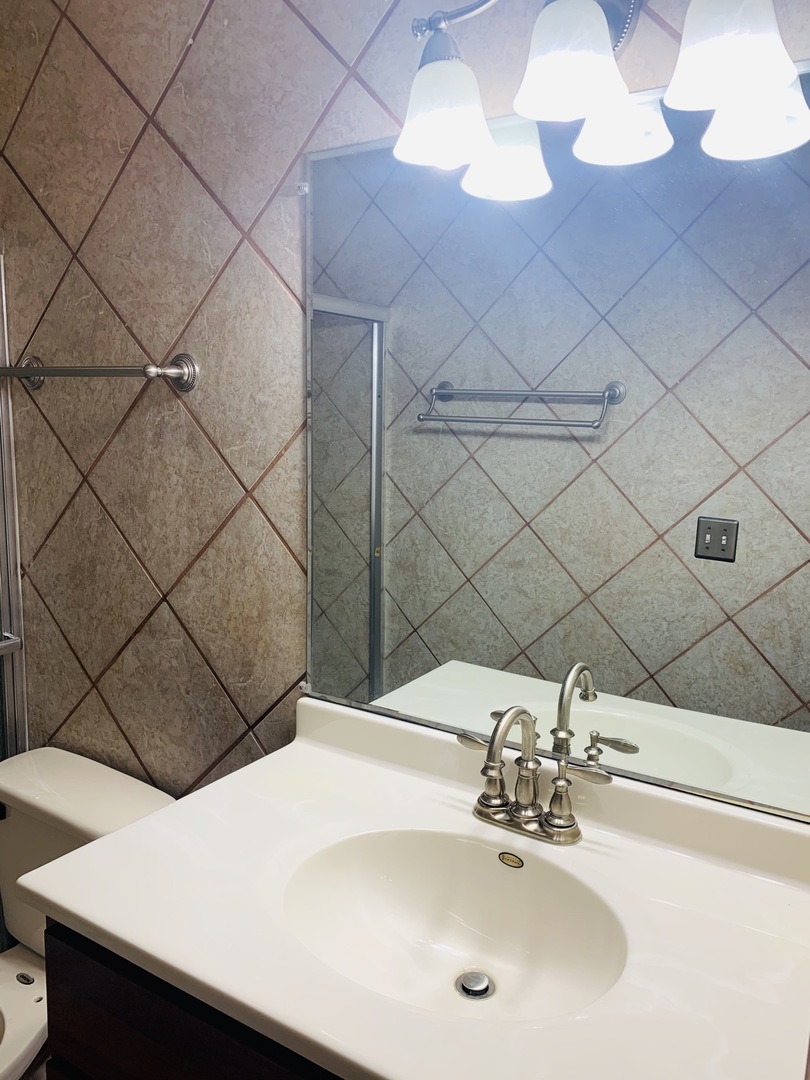 23 Surrey Road Montgomery, IL 60538 - Photo 17 of 22 a bathroom with a sink and a mirror