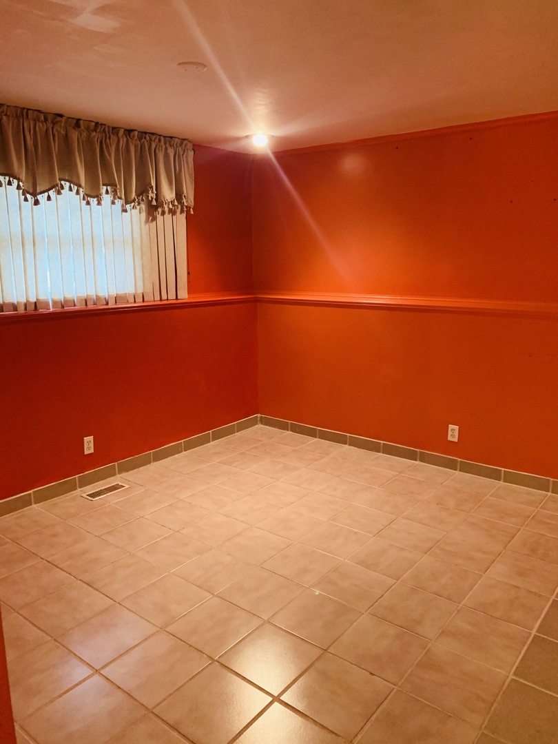 23 Surrey Road Montgomery, IL 60538 - Photo 8 of 22 a view of a room with wooden floor and windows