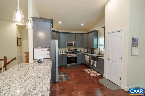 a kitchen with a refrigerator sink and cabinets