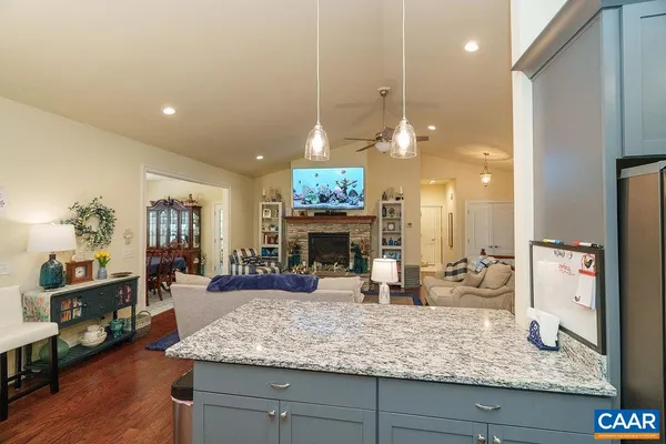 a kitchen with stainless steel appliances granite countertop a sink a stove and a refrigerator