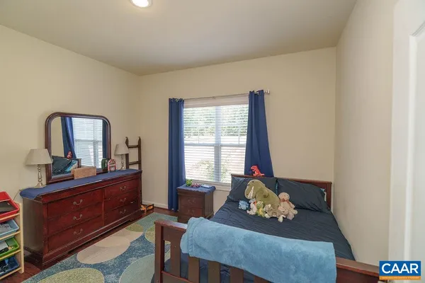 a living room with furniture and a dresser