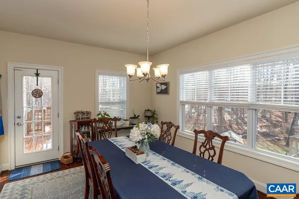 a view of a dining room with furniture and chandelier