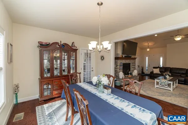 a kitchen with granite countertop a refrigerator and a stove top oven