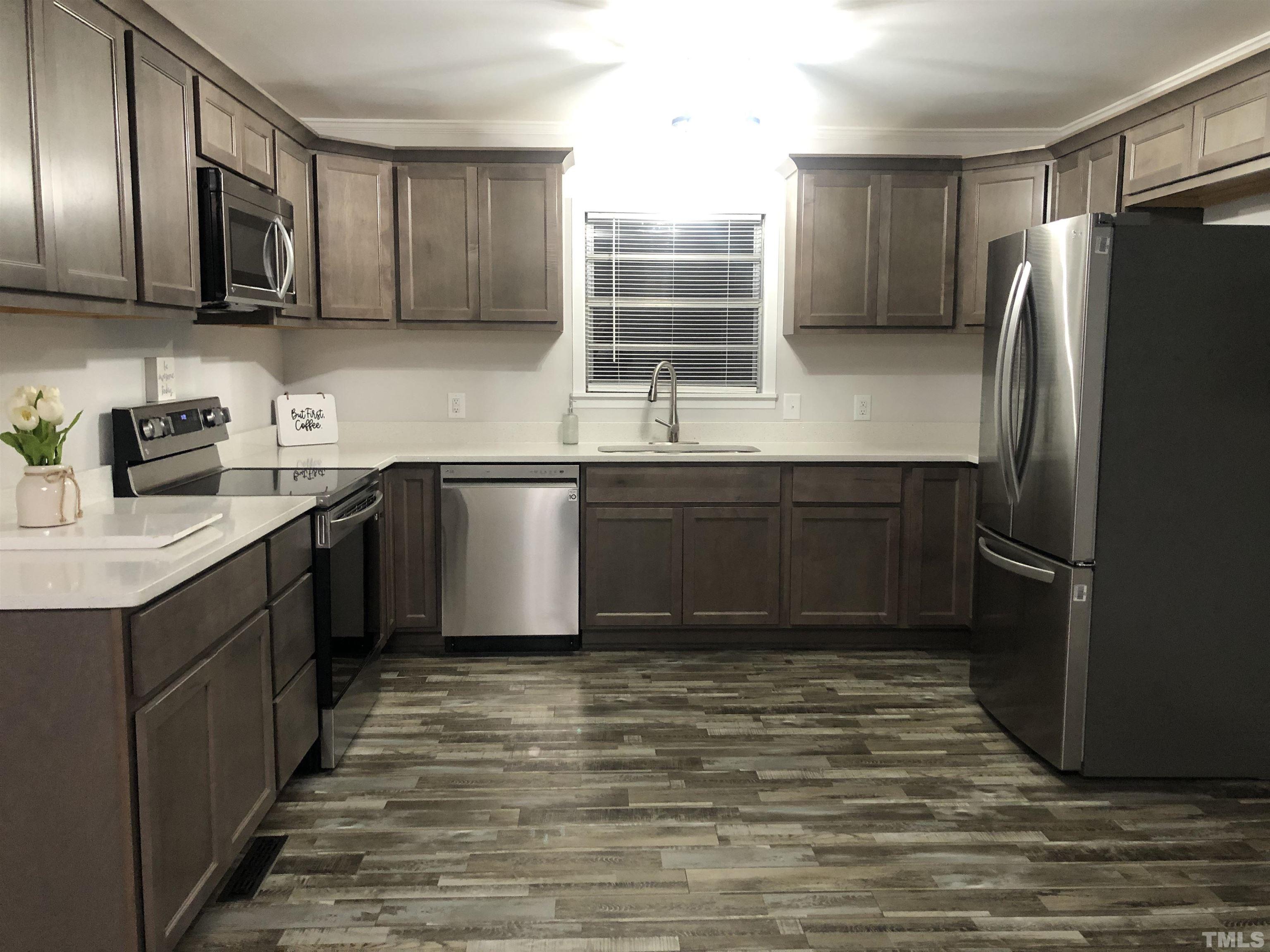 150 Community Drive Goldsboro, NC 27530 - Photo 12 of 30 a kitchen with stainless steel appliances granite countertop a sink stove and refrigerator