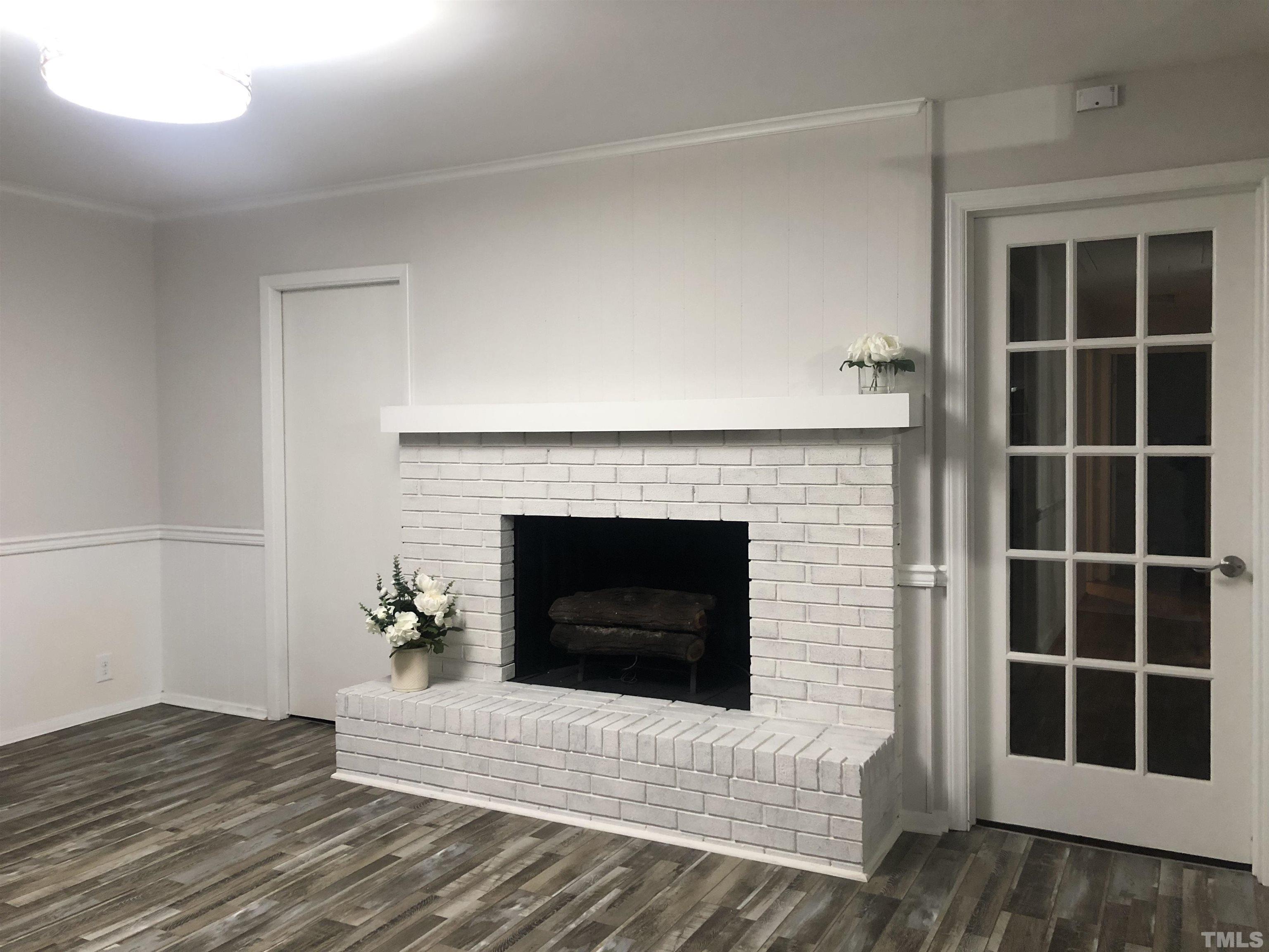 150 Community Drive Goldsboro, NC 27530 - Photo 10 of 30 a living room with a fireplace and a window