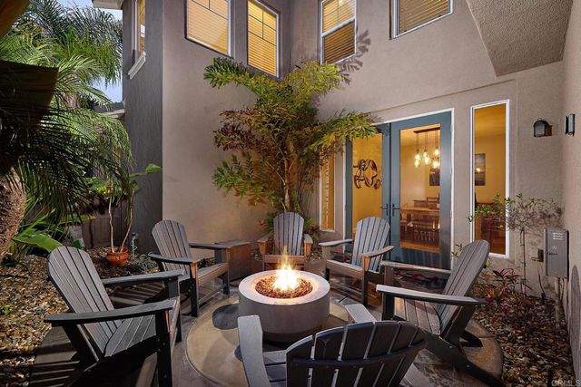 a view of a balcony with chairs and a potted plant