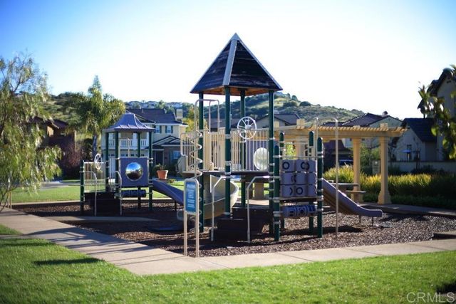 a view of a swimming pool with chairs and table in patio