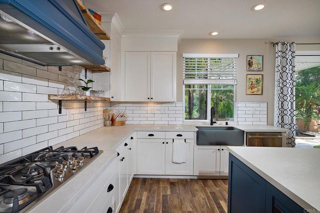 a kitchen with wooden cabinets and a stove top oven