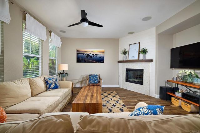 a living room with furniture fireplace and flat screen tv