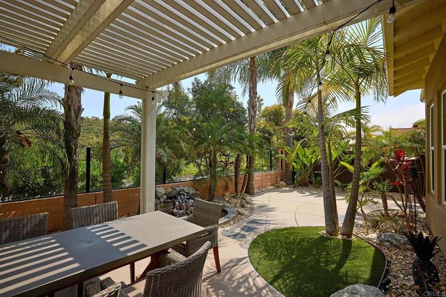 a view of a patio with table and chairs and potted plants