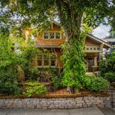 front view of a house with a tree